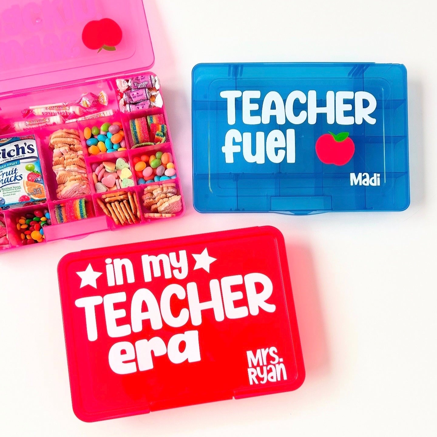 Assorted snack boxes designed for teachers, in red, blue, and pink colors with text personalizations such as 'Teacher fuel' and 'in my Teacher era'.