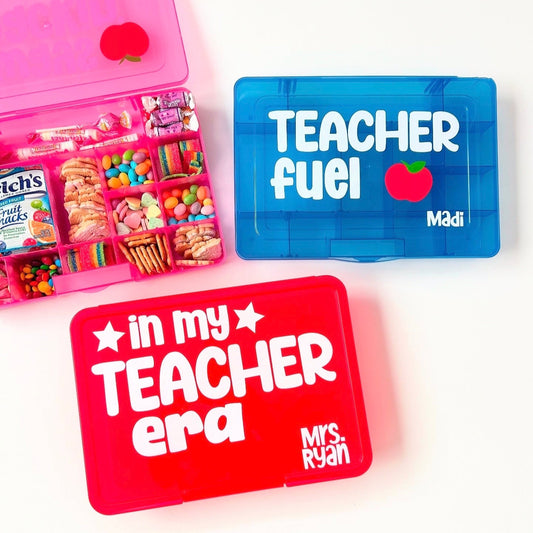 Assorted snack boxes designed for teachers, in red, blue, and pink colors with text personalizations such as 'Teacher fuel' and 'in my Teacher era'.
