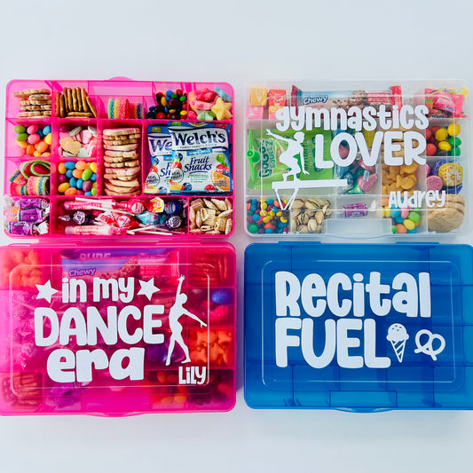 Assorted snack boxes with various designs related to dance and gymnastics, in pink, blue, and white colors, labeled with phrases like 'Gymnastics lover' and 'In my dance era'.