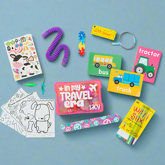 Assorted children's toys and activities spread out, including stickers, a slinky toy, flashcards, a small plastic animal, a box of crayons, and coloring pages.