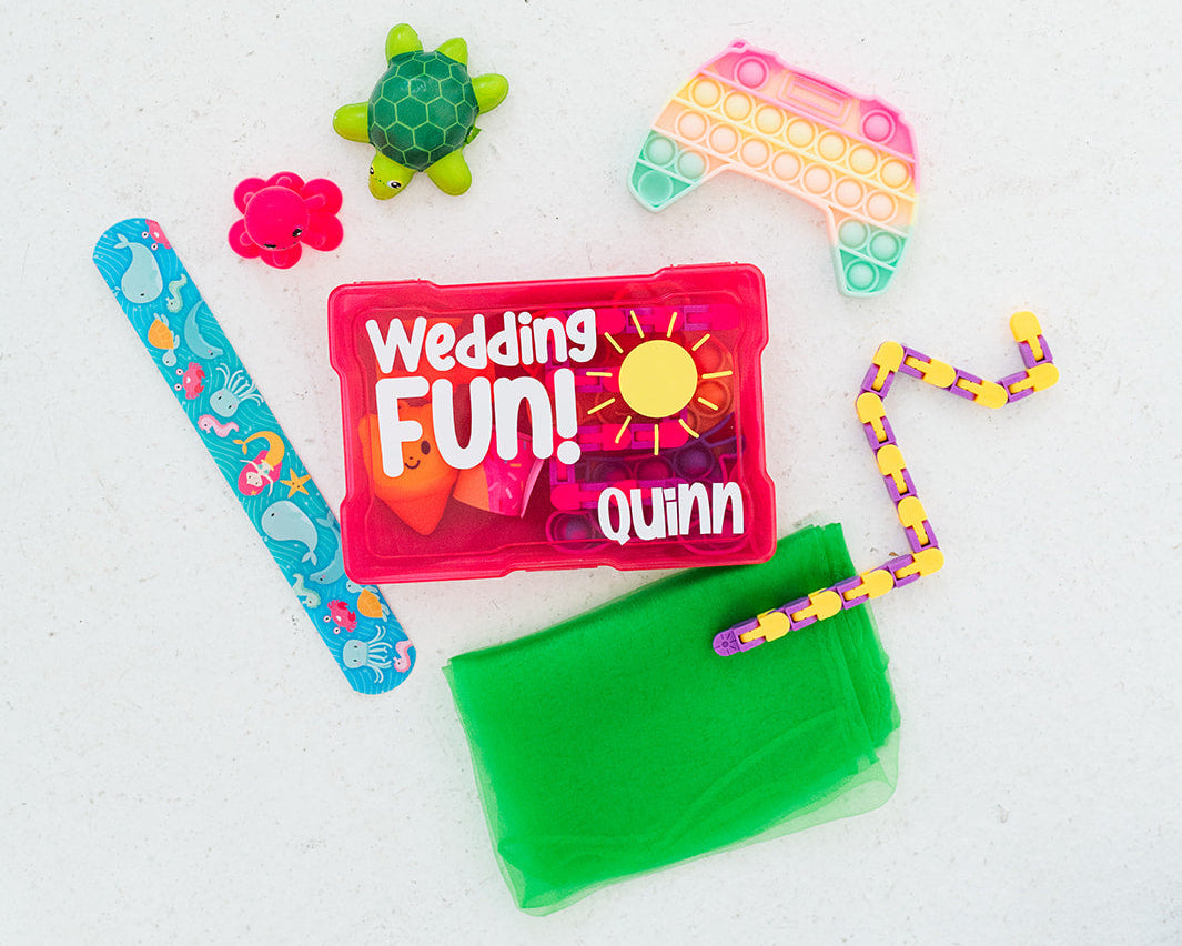 Colorful fidget toys and a 'Wedding Fun Quinn' box on a white background