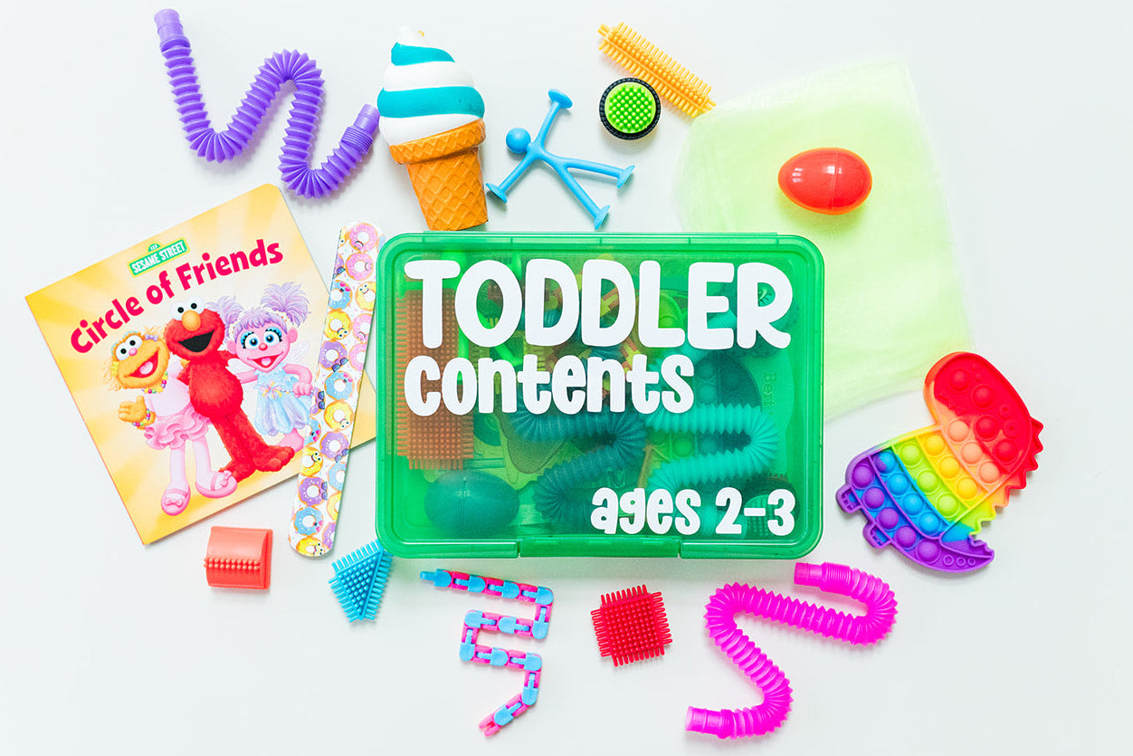 Assorted toys and a book for toddlers on a white background with a 'Toddlers Contents' sign.
