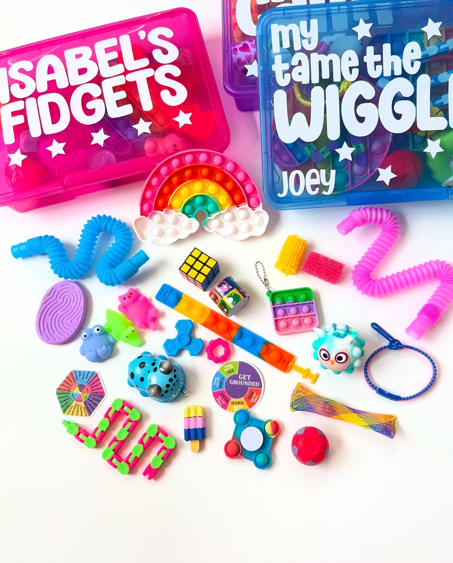 Collection of colorful fidget toys with personalized containers on a white background