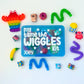 Colorful 'My Tame the Wiggles' kit with various toys on a white background