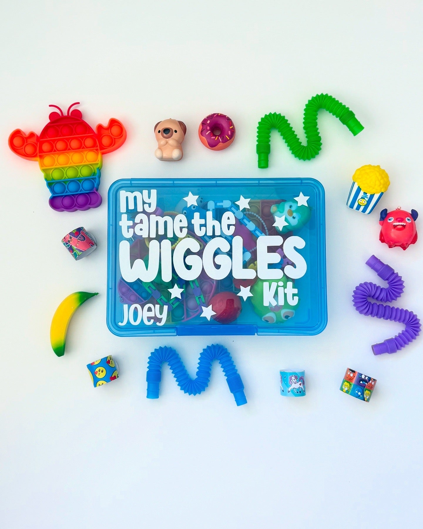 Colorful 'My Tame the Wiggles' kit with various toys on a white background