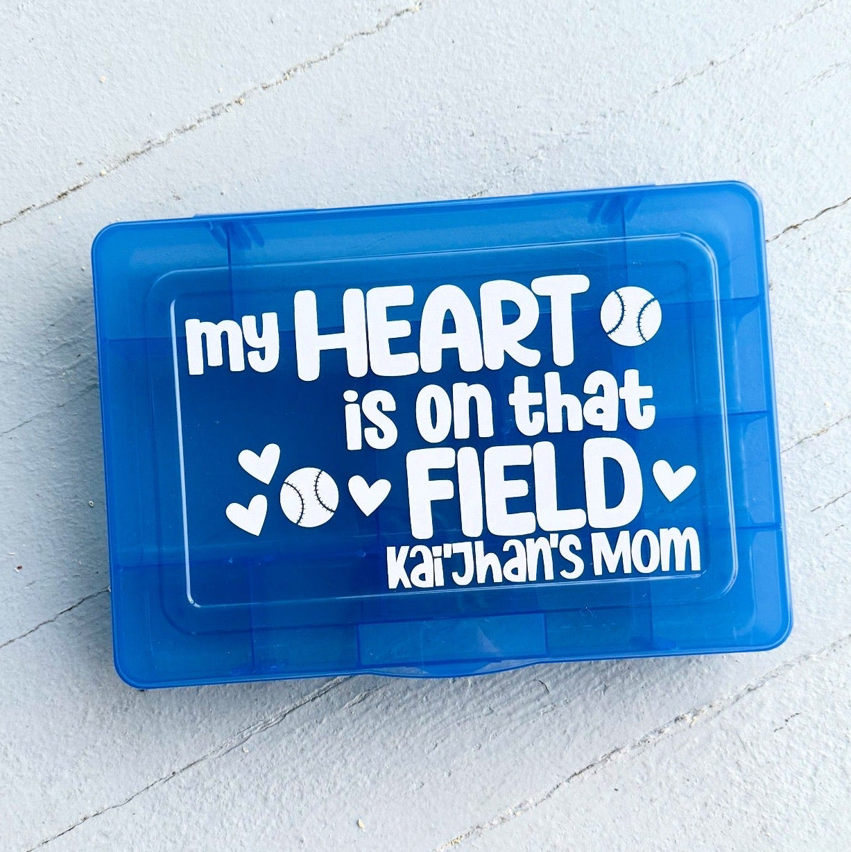 Blue rectangular object with text 'my HEART is on that FIELD kaijah's mom' on a light gray background