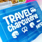 Blue container with 'Travel Charcuterie' text and icons on a white background