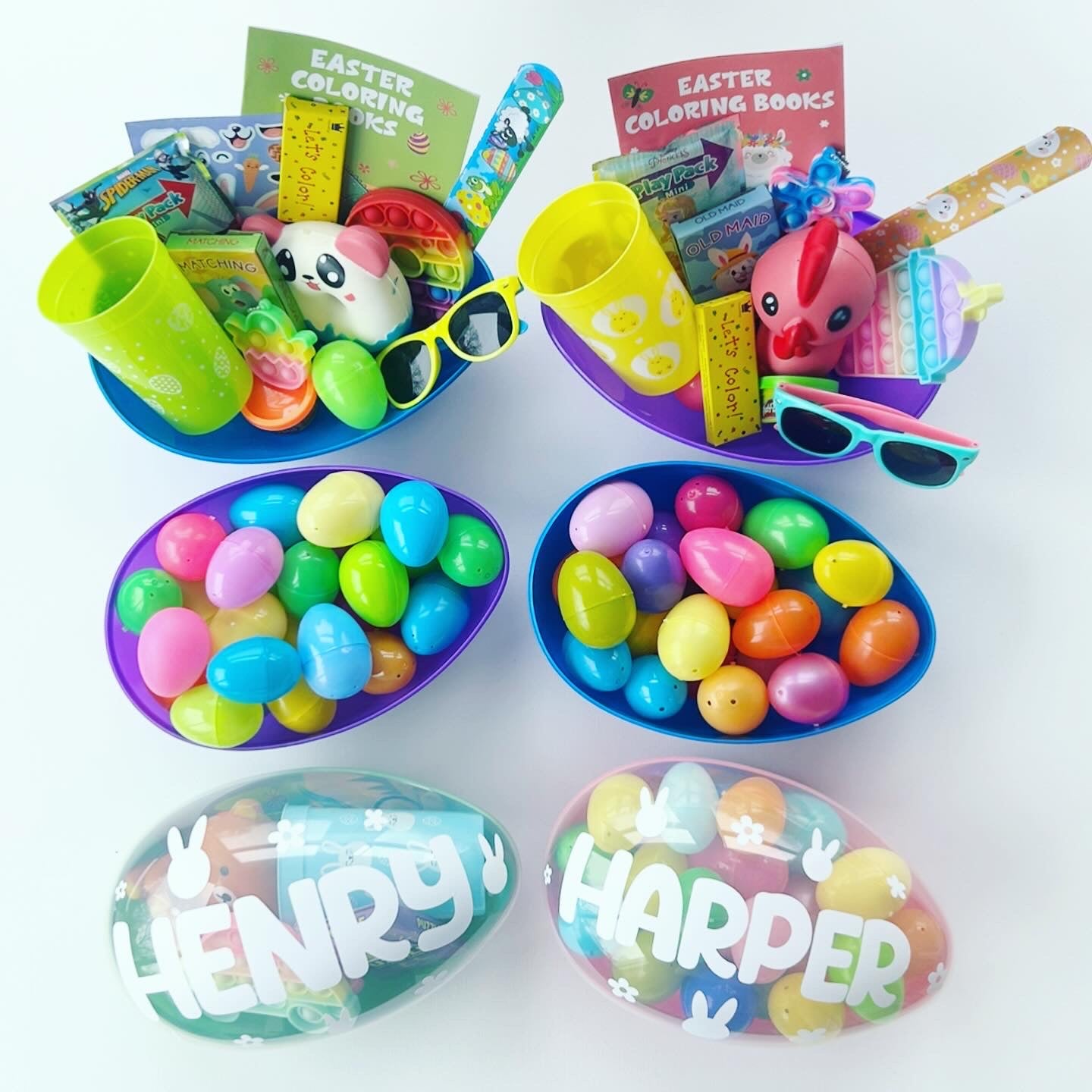 6 jumbo easter eggs. 2 jumbo easter eggs personalized with names Henry and Harper. 2 jumbo eggs with smaller plastic eggs inside. 2 open jumbo eggs with kids activities, toys, fidgets, sunglasses and cup.