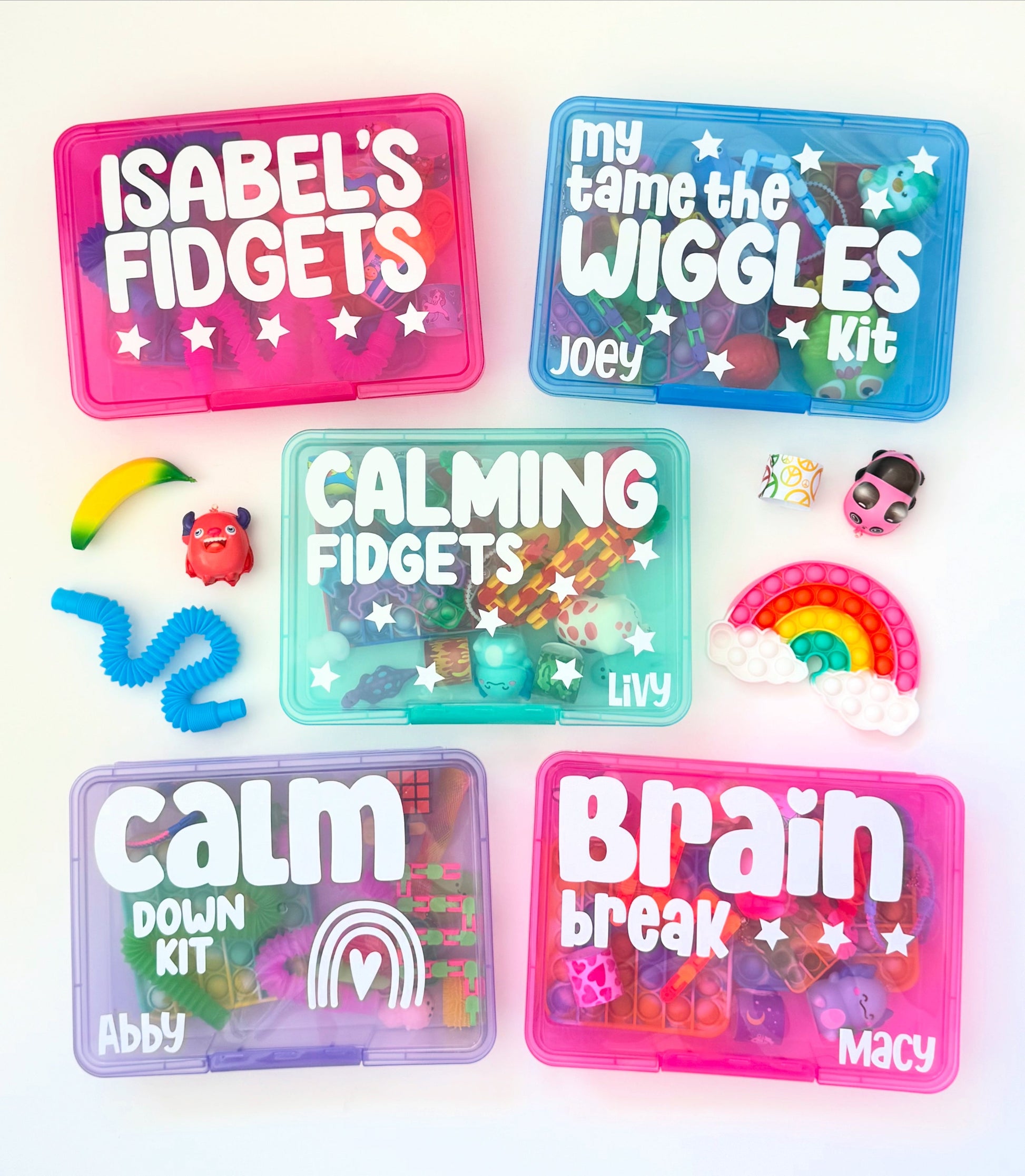 Collection of colorful fidget kits with names on them on a white background