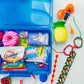 Blue tackle box with assorted items including toys and snacks on a white background