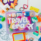 Travel-themed children's activity kit with colorful toys and items on a white background