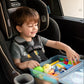 Child in a Graco car seat playing with a travel activity kit for kids. Blue plastic box is open in his lap with various toys and activities inside including fidgets, crayons, blocks, Oreo cookies, a green plastic egg, dinosaurs and more. 