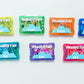 Colorful wedding-themed activity kits with mountain images on a white background. Each wedding favor for kids is personalized and filled with activities to keep kids entertained on your big day.
